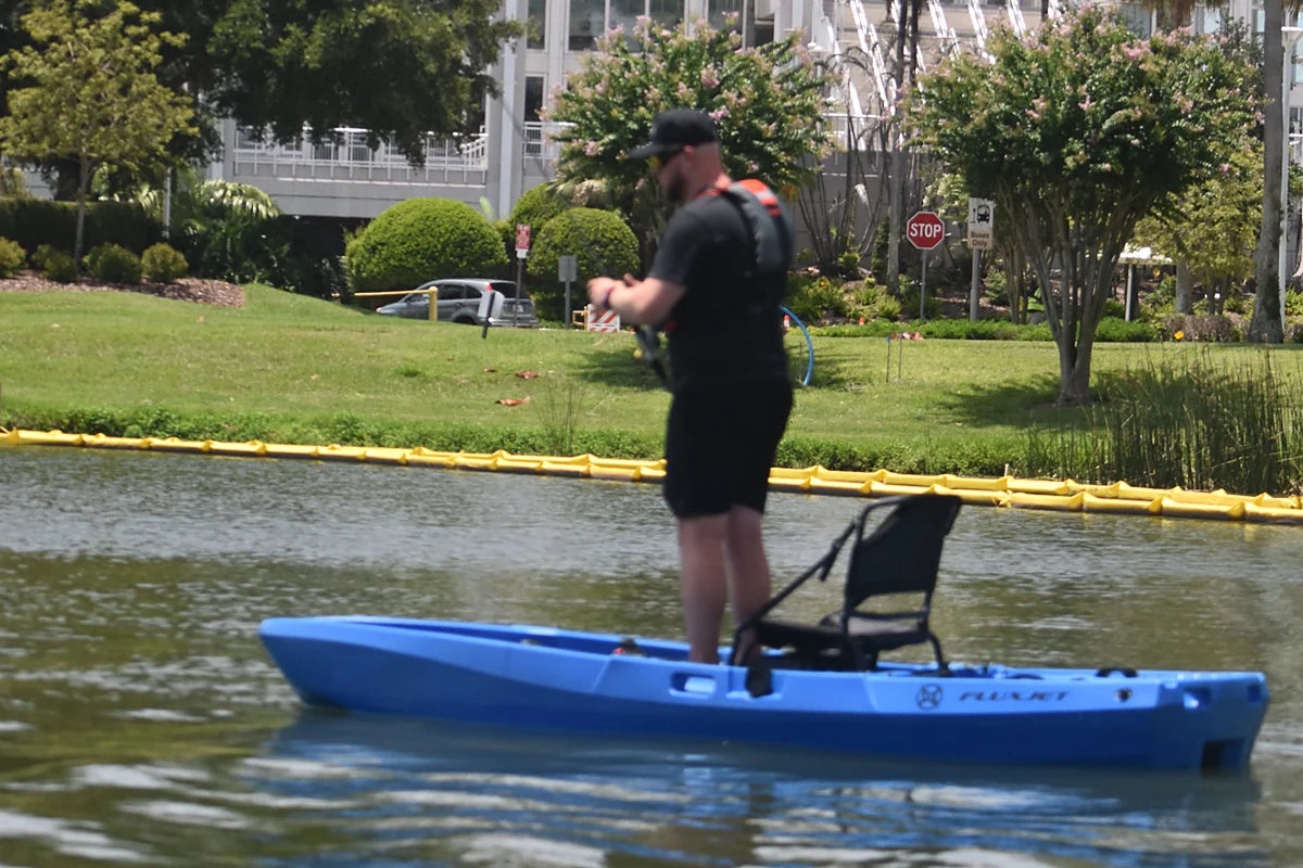 Angler standing on a blue FluxJet electric kayak