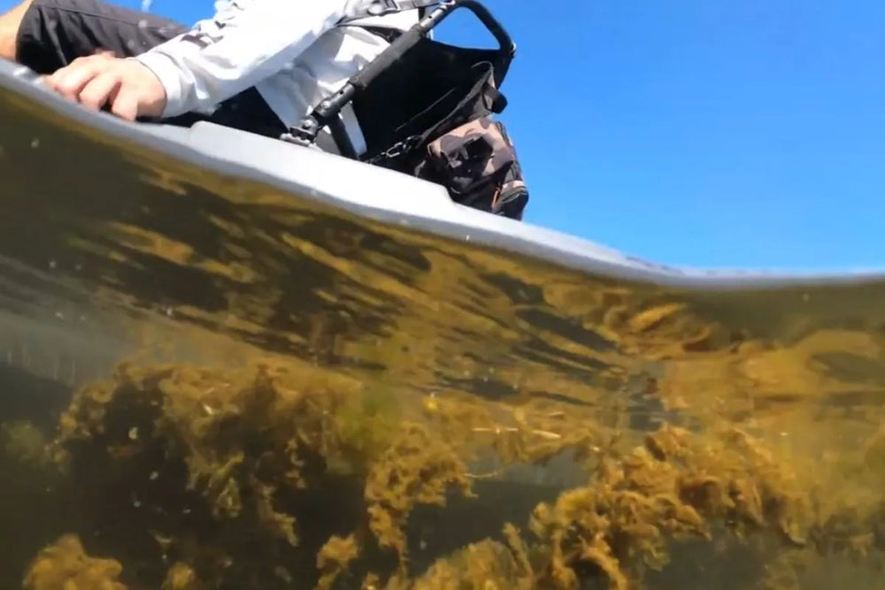 Underwater view of a FluxJet hull over shallow weeds