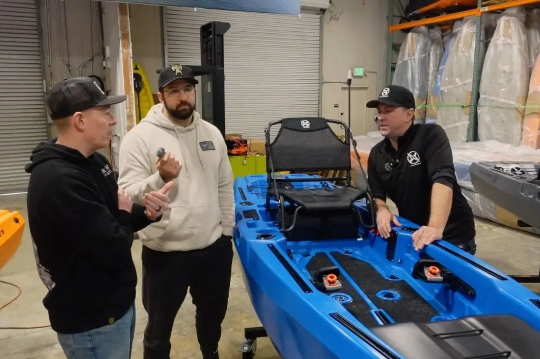 Jason Woods giving a tour of the blue FluxJet electric jet kayak features to Paul and Jeff from Aggressively Average Anglers inside the FluxJet warehouse.