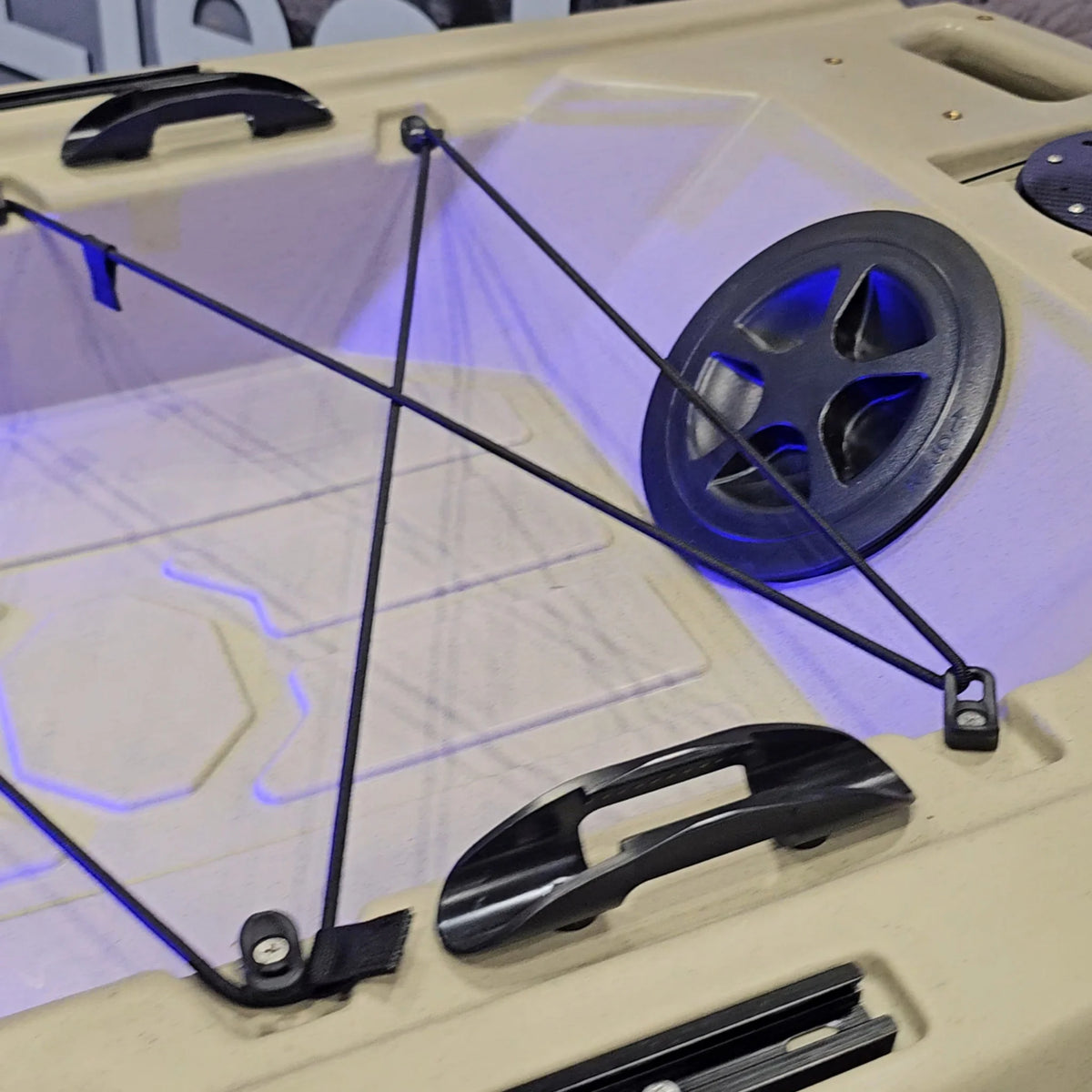 Bow deck of a tan FluxJet kayak with bungee, carry handles and LED lighting