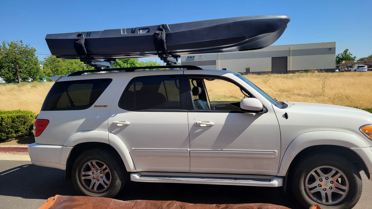 FluxJet electric kayak mounted on SUV roof rack for transport
