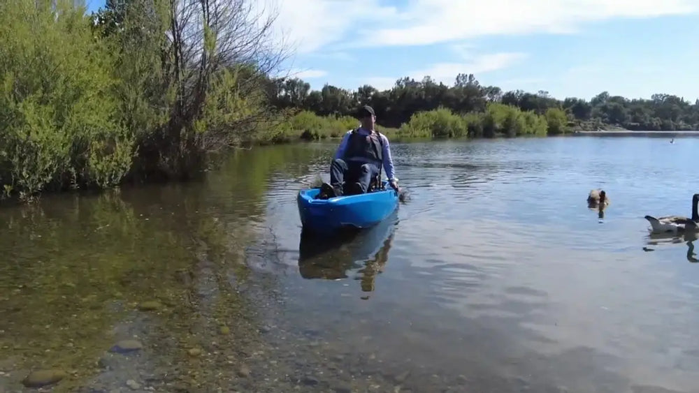 FluxJet electric kayak approaching a quiet shoreline