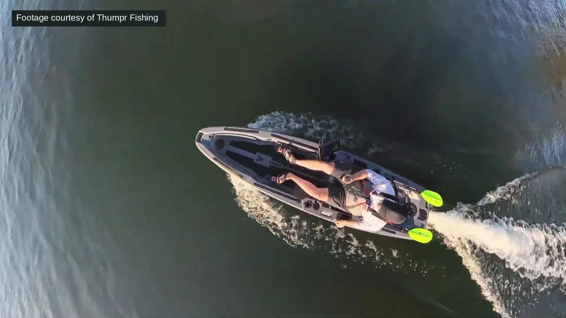 Aerial view of a gray FluxJet kayak under way with the angler seated and feet on the pedals