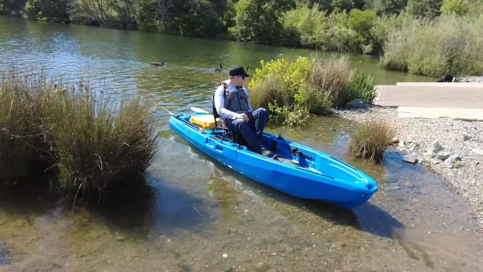 FluxJet kayak reversing in shallow water near the bank