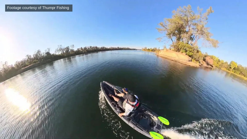 Aerial view of a FluxJet kayak cruising along a lake shoreline