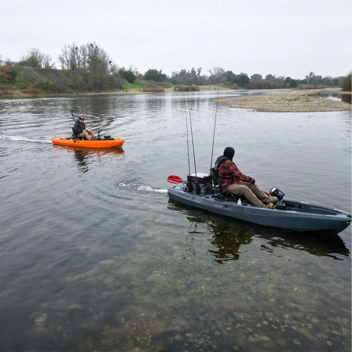 Two FluxJet kayaks traveling side by side on a shallow river with fishing gear mounted